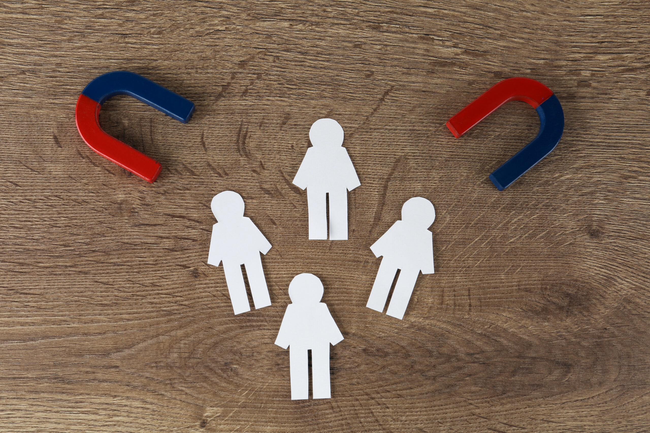 Magnet with paper people representing customer retention